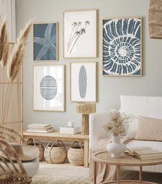 a living room filled with furniture and pictures on the wall