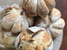 several loaves of bread sitting on top of a wooden table