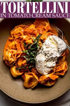 a bowl filled with pasta and sauce on top of a table