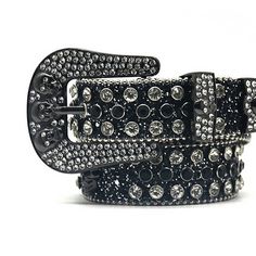 The black skull with black and crystal rhinestone belt is a fashionable accessory that can add a touch of edge and glamour to any outfit The belt features a large skull buckle with intricate details that give it a dark and mysterious vibe. The black and crystal rhinestones on the belt add a touch of sparkle and shine, making it perfect for adding some bling to your look. The black color of the belt makes it versatile and easy to pair with different outfits, whether you want to wear it with jeans Silver Belt With Rhinestone Rivets For Party, Edgy Black Belt Buckles, Black Adjustable Gothic Belt, Belt Store, Dark And Mysterious, Bling Belts, Country Music Concerts, Black Skull, Rhinestone Belt