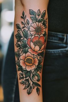 Floral tattoo with orange flowers and green leaves on a person's forearm. Traditional Flowers Tattoo Design, Old School Tattoo For Women, Neo Traditional Flower Tattoo Design, Traditional Flower Tattoo Sleeve, Old School Flower Tattoo, American Traditional Flower Tattoo, Color Tattoo Designs, Color Tattoo Ideas, Tattoos Trending