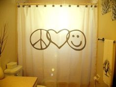 a peace sign shower curtain in a bathroom with the word peace on it's side