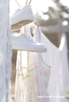 white shoes hanging on clothes line in the sun