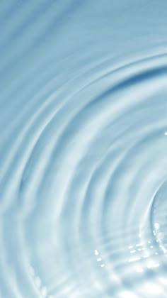 water ripples on the surface of a blue body of water with white circles around it