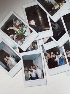 several polaroid photos of people posing for a group photo on a table with one person taking a selfie