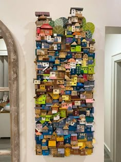 a wall hanging made out of small wooden houses