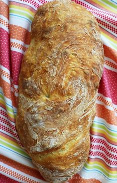 a loaf of bread sitting on top of a colorful towel