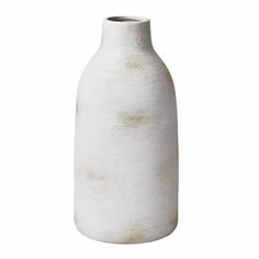 a white vase sitting on top of a table