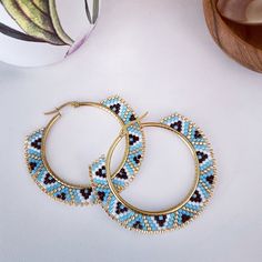 "These multi-colored blue beaded hoops are so fun! The perfect splash of color to add to your spring or summer dress or perfect with a white -T and jeans. 2\" round at the outermost edge of the beads" Aztec Earrings, Beads Craft Jewelry, Motifs Perler, Brick Stitch Earrings, Indian Earrings, Earring Tutorial