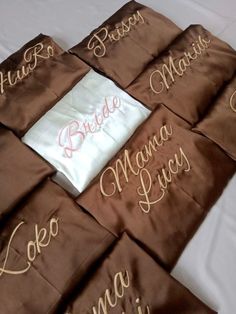 the bride and groom handkerchiefs are laid out on top of each other with their names