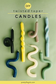 several different colored candles sitting next to each other on top of a green surface with the words diy twisted tape candles