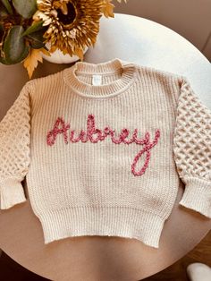 Custom, made to order toddler/baby chunky oversized sweaters!  I custom embroider your babies name in whatever font you like, great for birthdays, holidays, photo shoots, you name it ! These can get pretty custom, I provide sample colors but if you want something more custom, I can do it :) just message me on here!  Please provide the custom name you want with proper capitalization,   the color sweater, and name color you want with the order in the box below :) Thank you. Knit Name Sweater, Name Sweater Baby, Name Sweater, Chunky Oversized Sweater, Custom Sweaters, Knit Baby Sweaters, Toddler Sweater, Name Embroidery, Oversized Sweaters