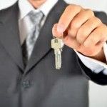 a man in a suit is holding a key