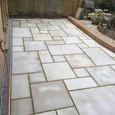 a brick patio being worked on by a worker