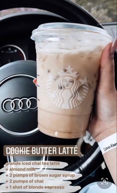 a person holding up a drink in their hand with the words dokie butter latte on it