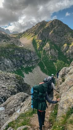 people hiking up the side of a mountain