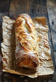 a loaf of bread sitting on top of a piece of wax paper