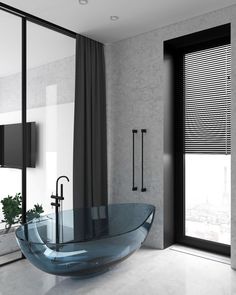 a bathroom with a large glass tub next to a window