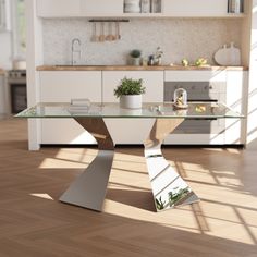 a modern glass table in the middle of a kitchen with wooden floors and white cabinets