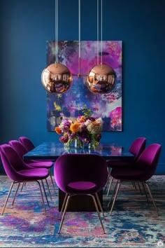 a dining room with blue walls and purple chairs