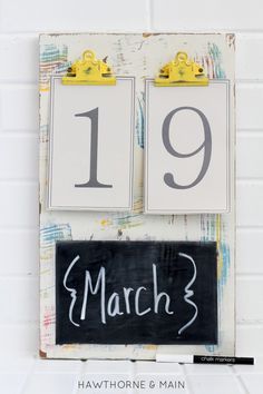 a calendar with the date march 3 written on it next to a chalkboard sign