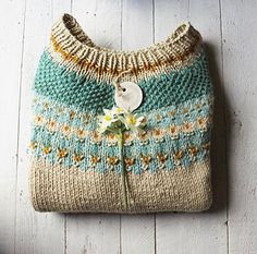 a knitted purse with a flower on it