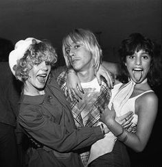 black and white photograph of three women with their mouths open while one woman is holding her arm around the other