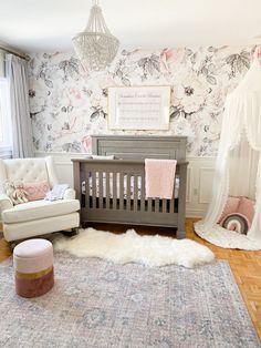 a baby's room with floral wallpaper and pink accents, including a crib