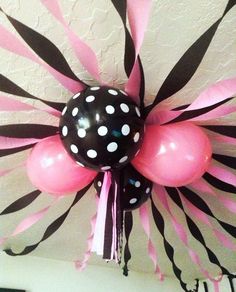 some balloons that are in the shape of a zebra print ballon with black and white stripes