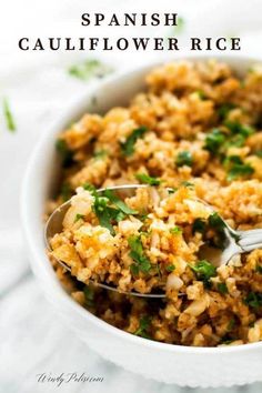 a white bowl filled with rice and garnished with cilantro