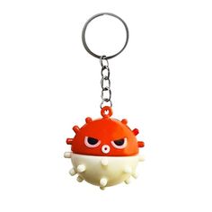 an orange and white object with eyes on it's face is hanging from a key chain