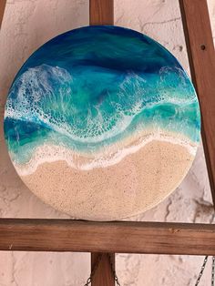 a blue and white plate sitting on top of a wooden shelf next to a wall