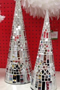 two christmas trees made out of magazines and pictures