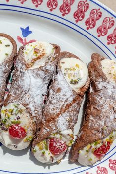 several pastries on a plate covered in powdered sugar