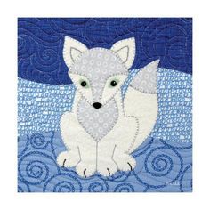 a white fox sitting on top of a blue and white quilted wall hangings