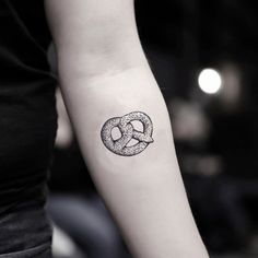 a black and white photo of a person's arm with a tattoo on it