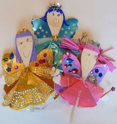 there are many little dolls on the stick together in this group, one is wearing a tiara and the other is holding an umbrella