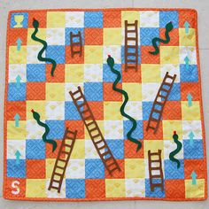 an orange and blue quilt with ladders on it