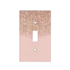 a light switch cover with pink and gold glitter