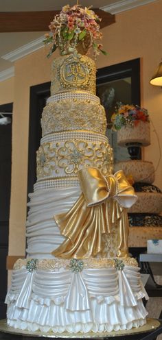 a wedding cake with gold and white decorations