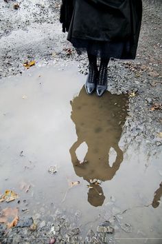 a person standing in the middle of a puddle