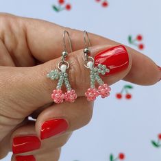 These beautiful beaded Cherry earrings are small and simple, which makes them perfect for everyday wear, but also suitable for special occasions.  ✤ SIZE (Approx.): ▸ Lenght: 2 cm (0.79 inches). ✤ MATERIAL: ▸ Pastel red and pastel green seed beads (size 11/0). ▸ Strong and durable beading thread. ▸ High quality stainless steel ear wire. Please note that colors may appear slightly different due to variations in monitors and browsers. ✤ SHIPPING: ▸ I will ship as soon as possible, approximately in Cherry Bead Earrings, Dainty Beaded Earrings With Round Beads, Dainty Beaded Earrings With Round Beads As Gift, Wire Beaded Earrings, Small Beads Jewelry, Beaded Cherry, Seed Beads Earrings, Fruit Summer, Pastel Red