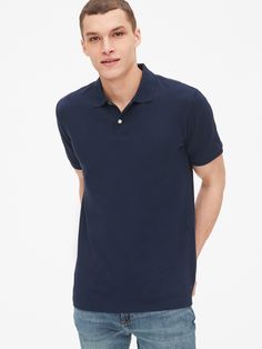 Soft, stretch pique knit with moisture-wicking properties.  Short sleeves with flat rib-knit cuffs.  Flat rib-knit polo collar.  Button placket.  Side vents at hem. Navy Short Sleeve Polo Shirt With Ribbed Collar, Classic Navy Polo Shirt With Ribbed Collar, Navy Short Sleeve Polo Sweater With Ribbed Collar, Blue Collared T-shirt With Ribbed Collar, Blue Short Sleeve Cotton Polo Sweater, Casual Blue Polo Sweater With Collared Neckline, Casual Navy Collared Polo Sweater, Classic Navy Cotton Polo Shirt, Navy Cotton Polo Shirt With Ribbed Collar