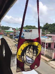 a bag hanging from the side of a building with an image of anime character on it