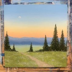 a painting of a dirt road in the middle of a field with trees and mountains