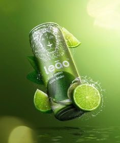 a can of iced tea with limes and leaves floating in the air over water