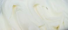 a bowl filled with white frosting sitting on top of a table