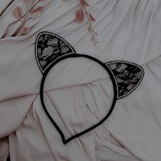 a cat ears headband laying on top of a bed