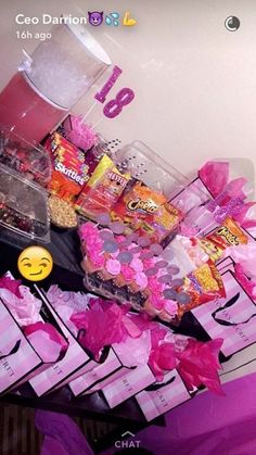 a table topped with lots of candy and candies next to a sign that says love