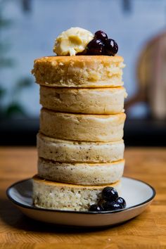 a stack of pancakes with blueberries and butter on top